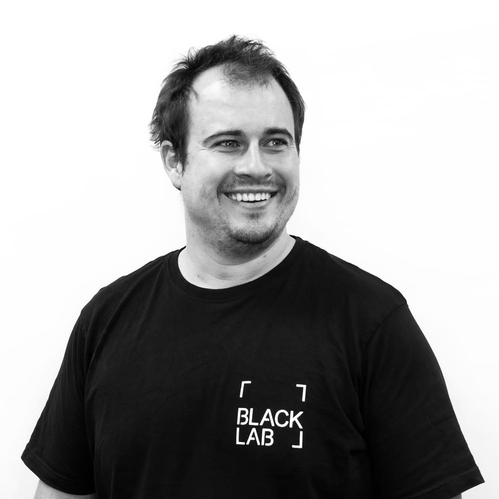 ceo daen simmat smiling in black and white