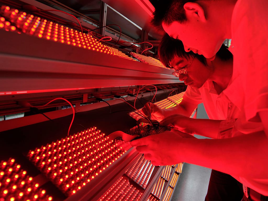 two chinese males working on electronics