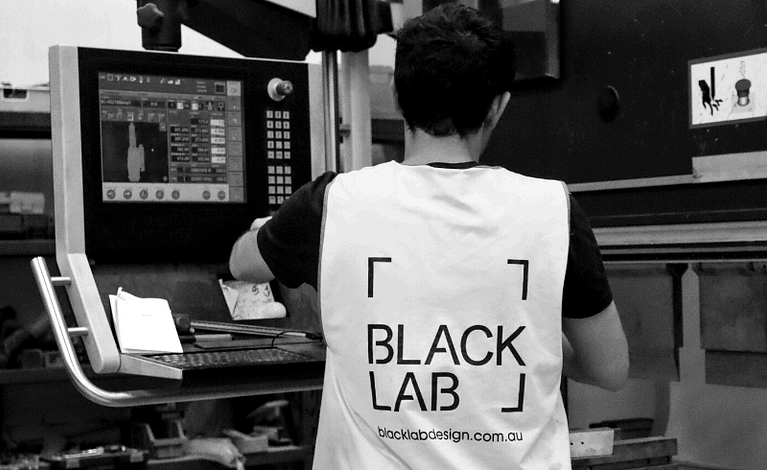 black and white image of man programming machine