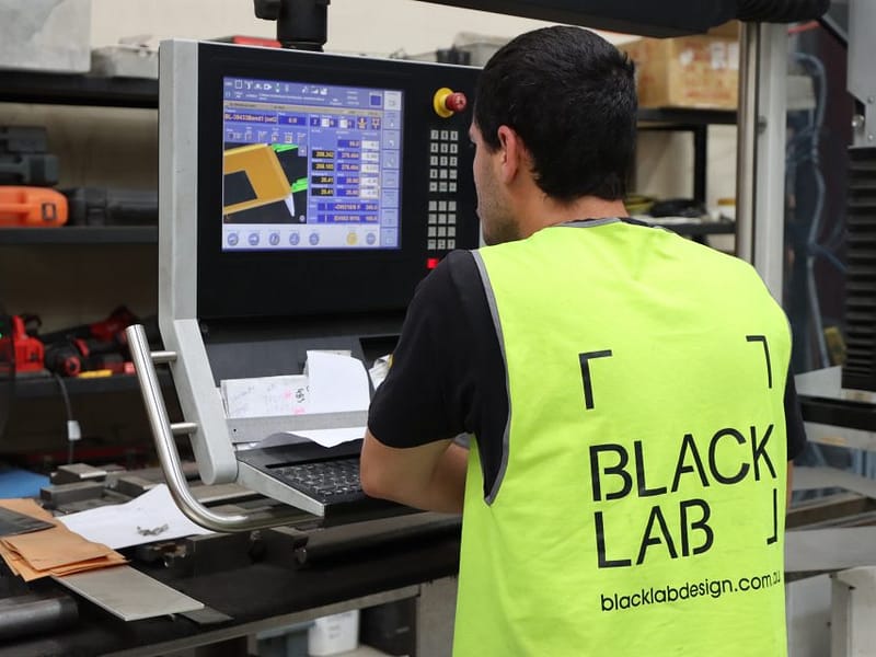 man programming bending machine