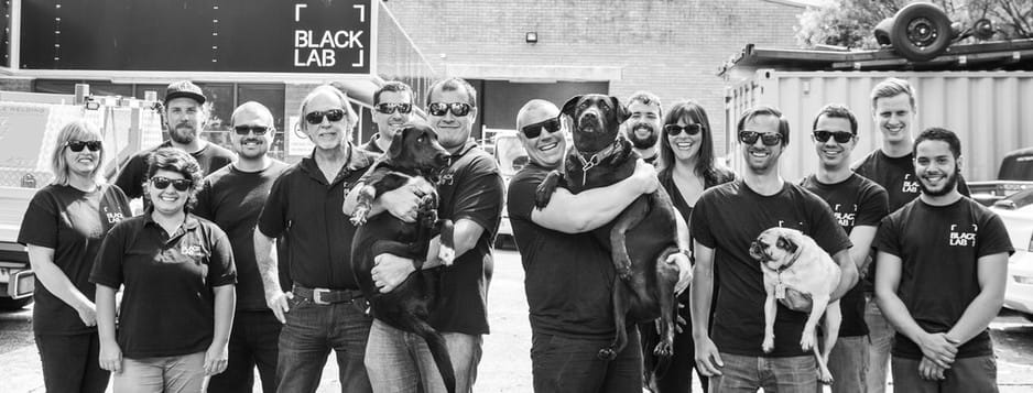 black lab team photo in black and white